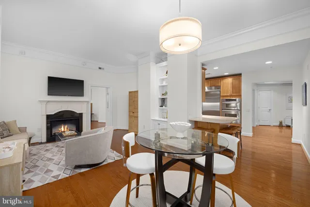 a living room with furniture a fireplace and a table