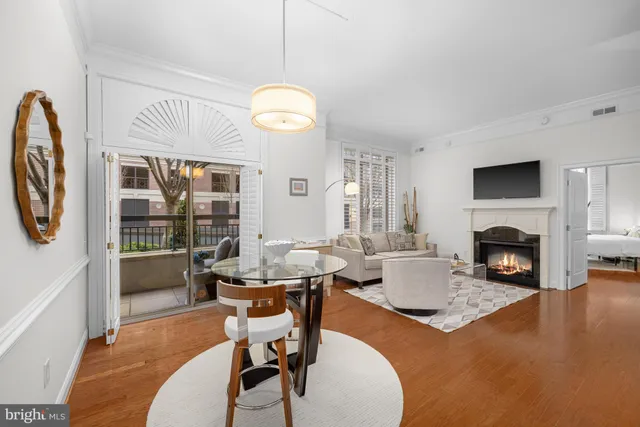a living room with furniture a fireplace and a large window