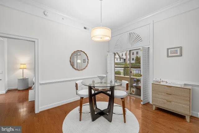 a view of a room that has a table and a chair in it