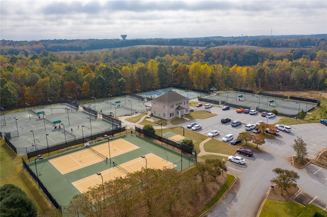 119 Turnberry Road Anderson, SC 29621 - Photo 49 of 50 An aerial view showcases multiple tennis courts and a clubhouse, surrounded by abundant greenery.
