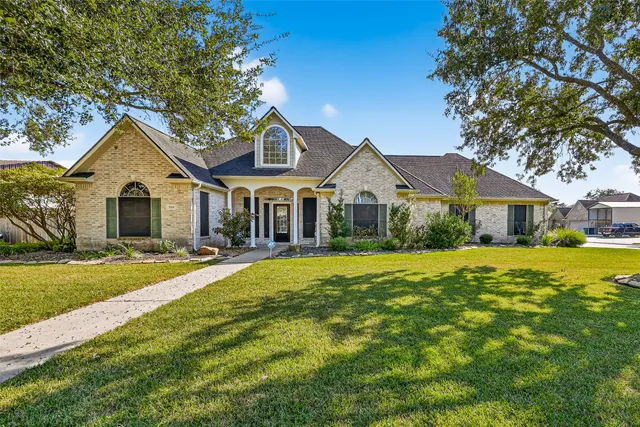 a front view of a house with yard porch and furniture