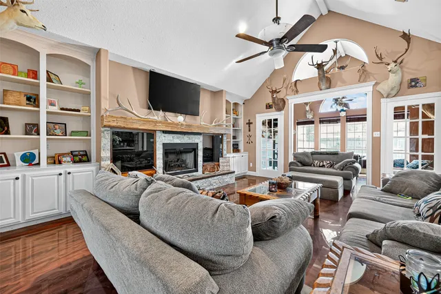 a living room with furniture fireplace and flat screen tv