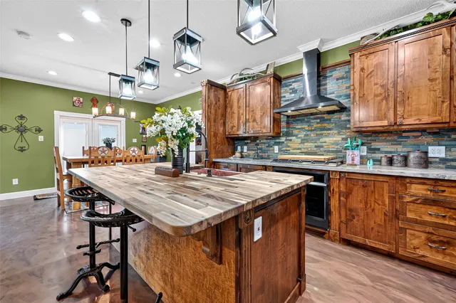 a kitchen with stainless steel appliances granite countertop a kitchen island a stove a table and chairs in it