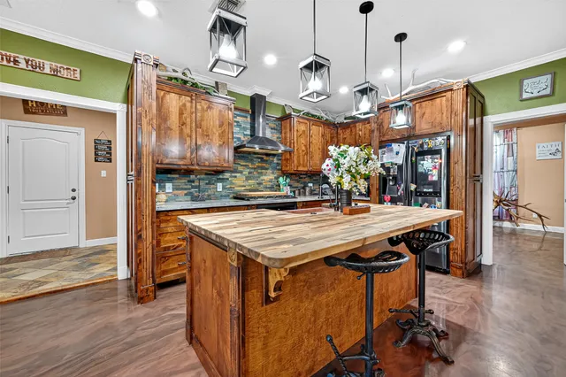 a kitchen with stainless steel appliances granite countertop a stove a refrigerator and a wooden cabinets