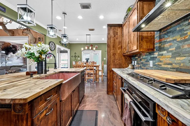 a view of a dining room with furniture a chandelier and wooden floor