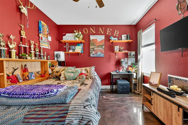 a bedroom with a bed and a chandelier