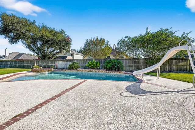 a view of a house with a big yard and a large tree