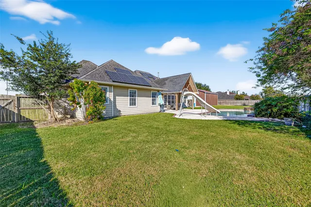 a view of swimming pool with a garden and deck