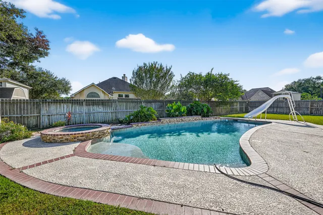 a view of a house with a yard and sitting area