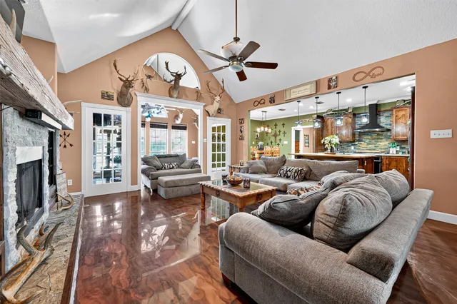 a living room with fireplace furniture and a large window