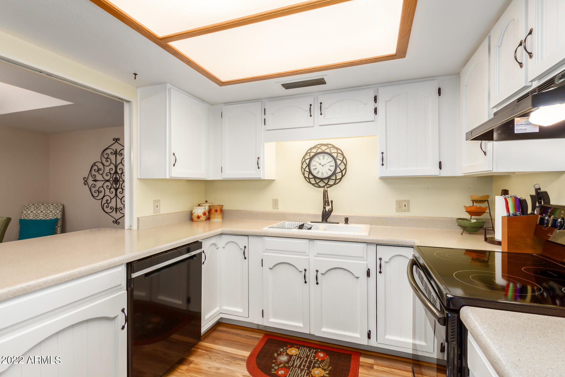 7005 East Broadway Road, Unit 28 Mesa, AZ 85208 - Photo 11 of 27 a kitchen with a sink a stove and cabinets