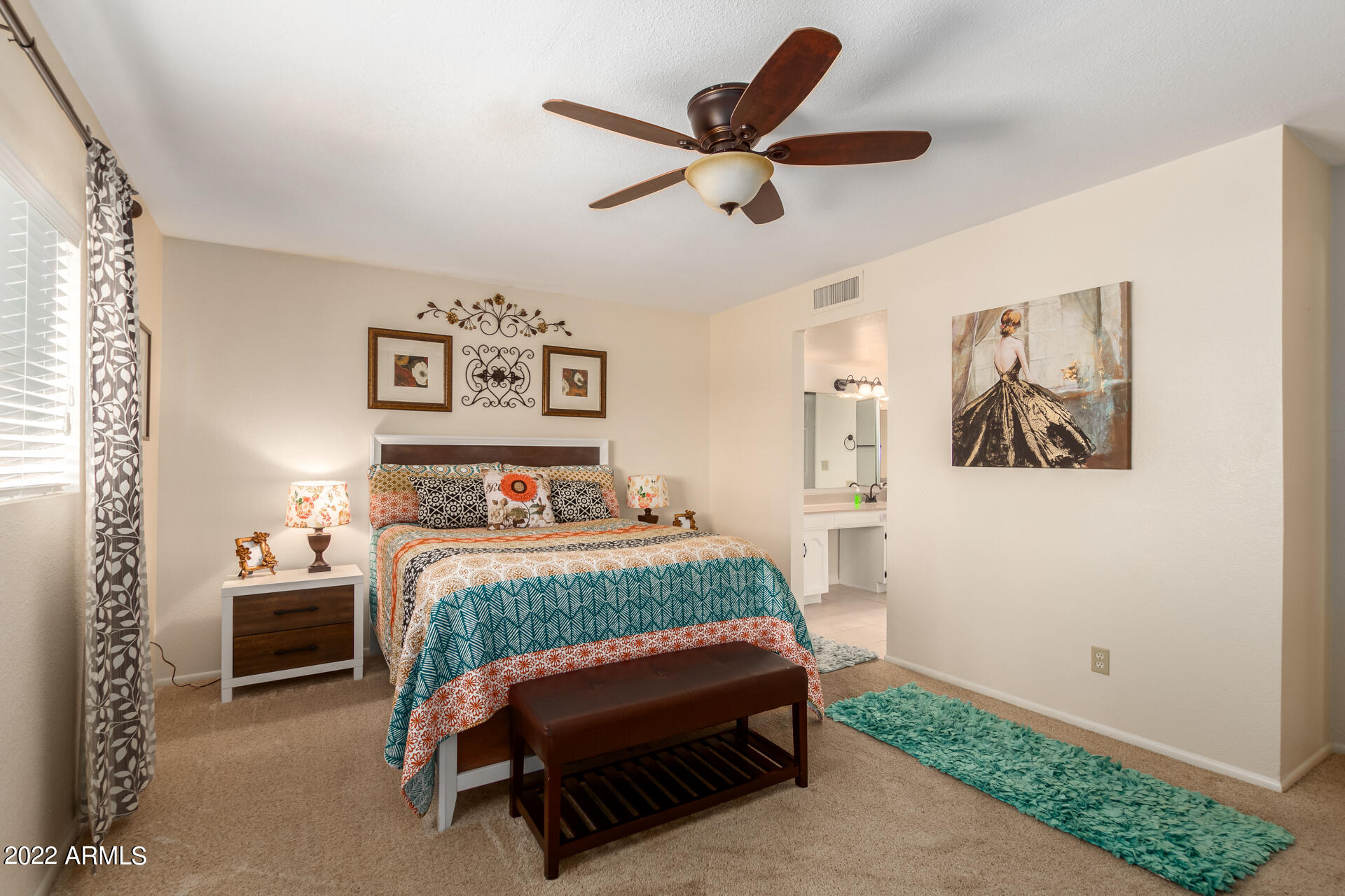 7005 East Broadway Road, Unit 28 Mesa, AZ 85208 - Photo 13 of 27 a bedroom with a bed and a painting on the wall