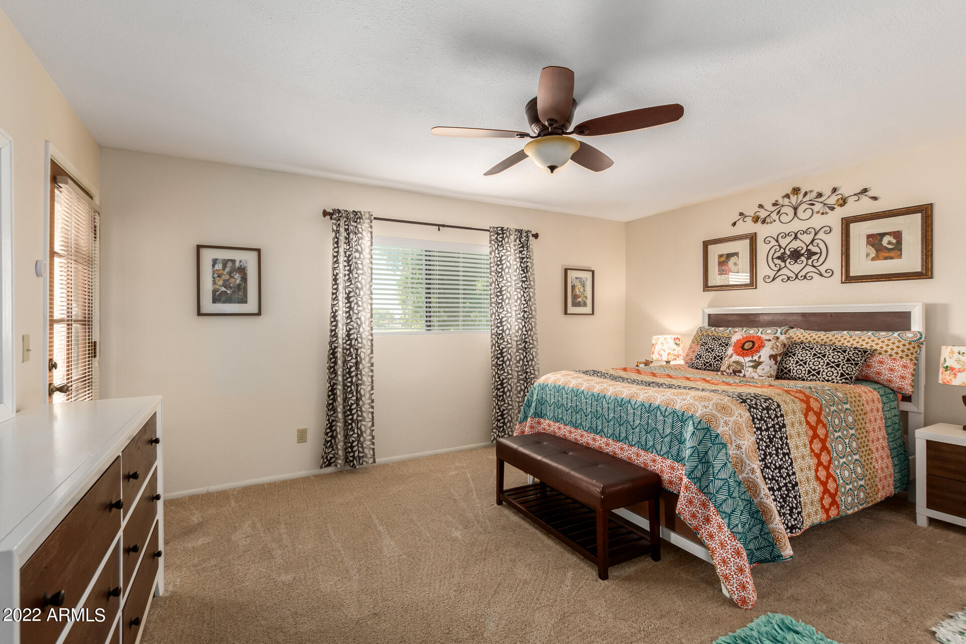 7005 East Broadway Road, Unit 28 Mesa, AZ 85208 - Photo 15 of 27 a spacious bedroom with a bed and a chandelier