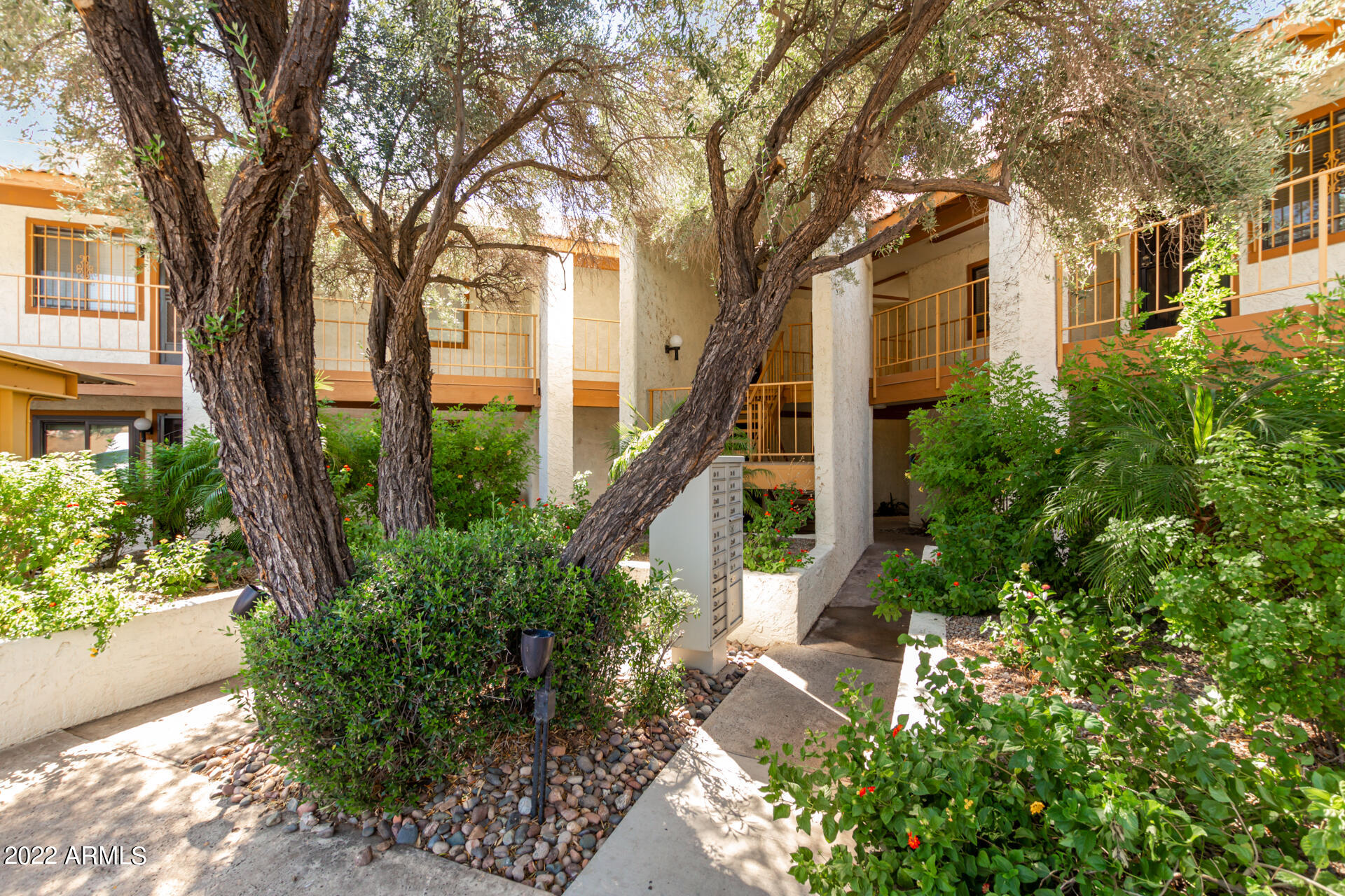 7005 East Broadway Road, Unit 28 Mesa, AZ 85208 - Photo 2 of 27 a front view of a house with garden
