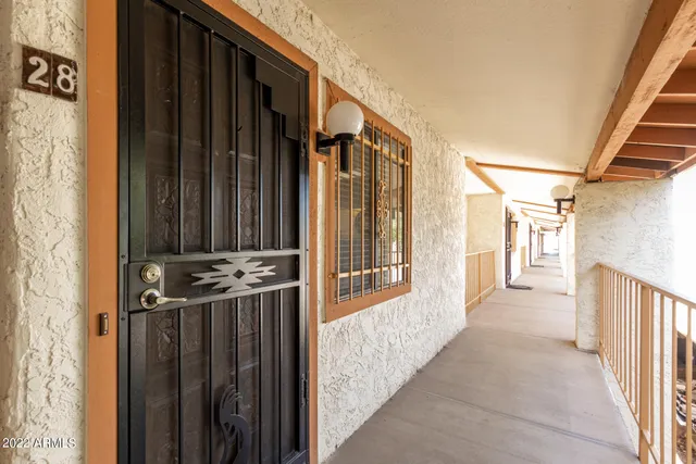 a view of a house with a door and wooden door