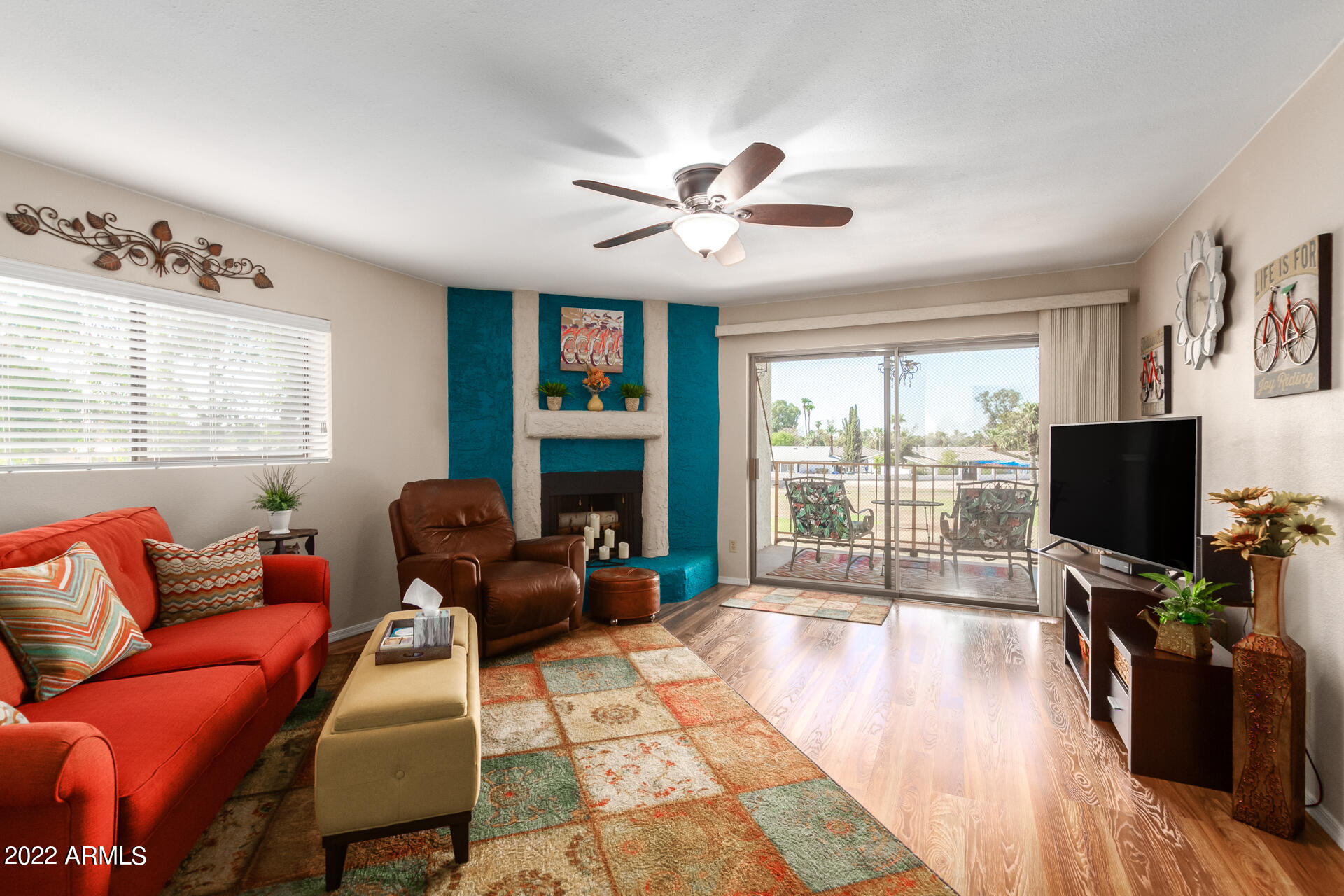 7005 East Broadway Road, Unit 28 Mesa, AZ 85208 - Photo 5 of 27 a living room with furniture a flat screen tv and a large window