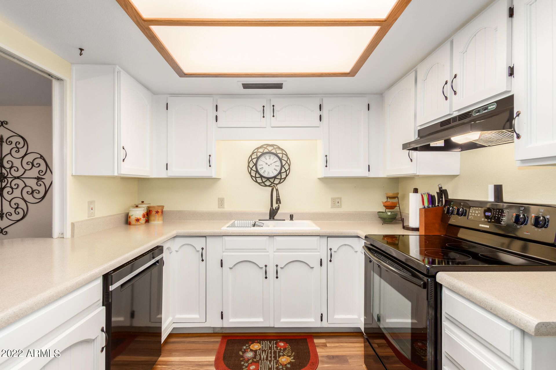 7005 East Broadway Road, Unit 28 Mesa, AZ 85208 - Photo 10 of 27 a kitchen with stainless steel appliances granite countertop a sink a stove and cabinets