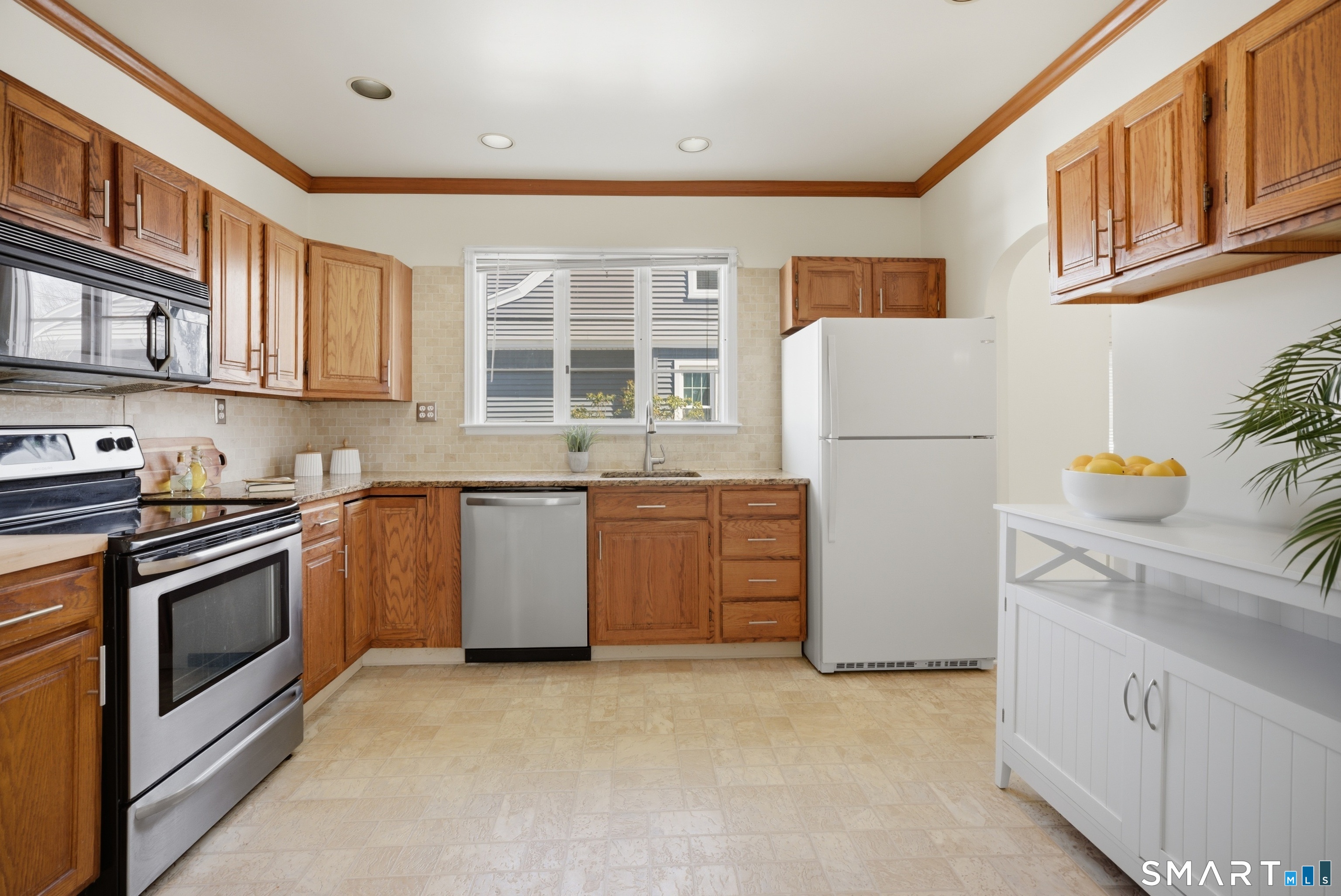224 Homeland Street Fairfield, CT 06825 - Photo 11 of 37 a kitchen with a stove a sink and a refrigerator