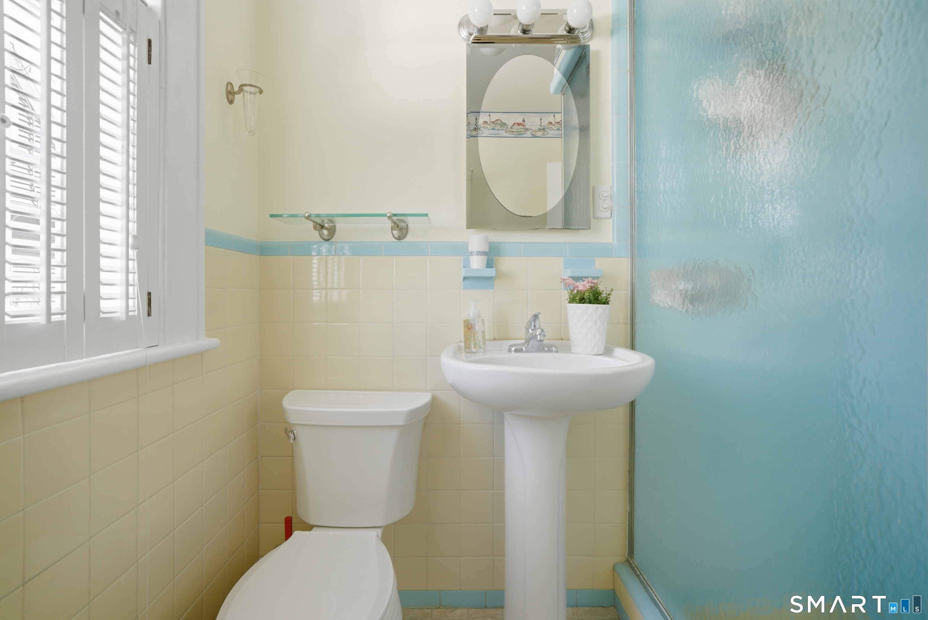 224 Homeland Street Fairfield, CT 06825 - Photo 14 of 37 a bathroom with a sink a toilet and a mirror