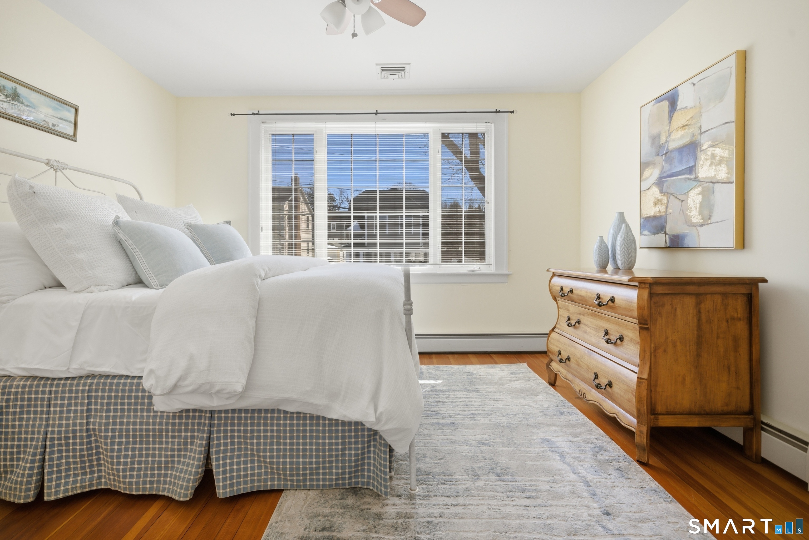 224 Homeland Street Fairfield, CT 06825 - Photo 19 of 37 a spacious bedroom with a bed and a window