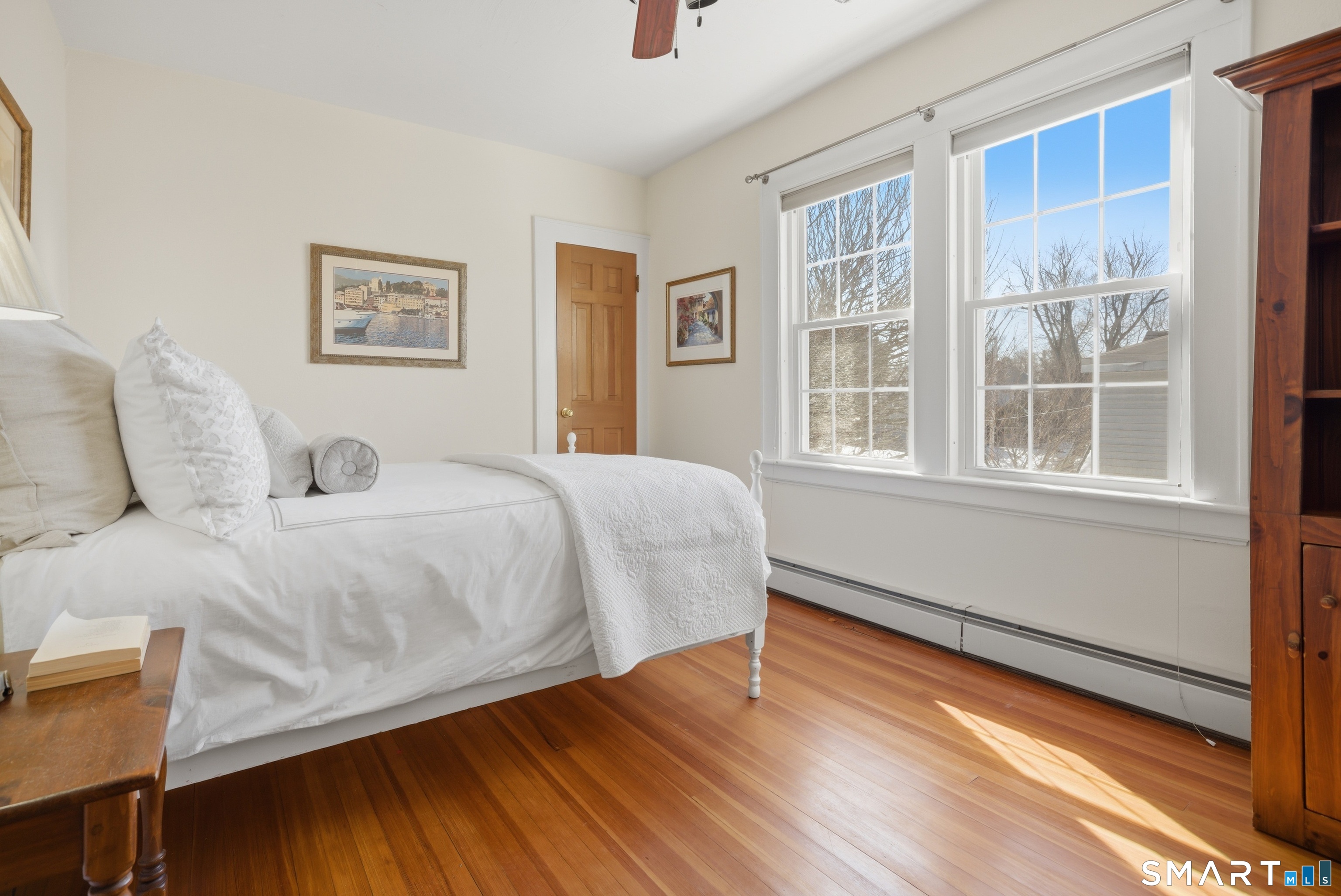 224 Homeland Street Fairfield, CT 06825 - Photo 20 of 37 a bedroom with a bed and wooden floor