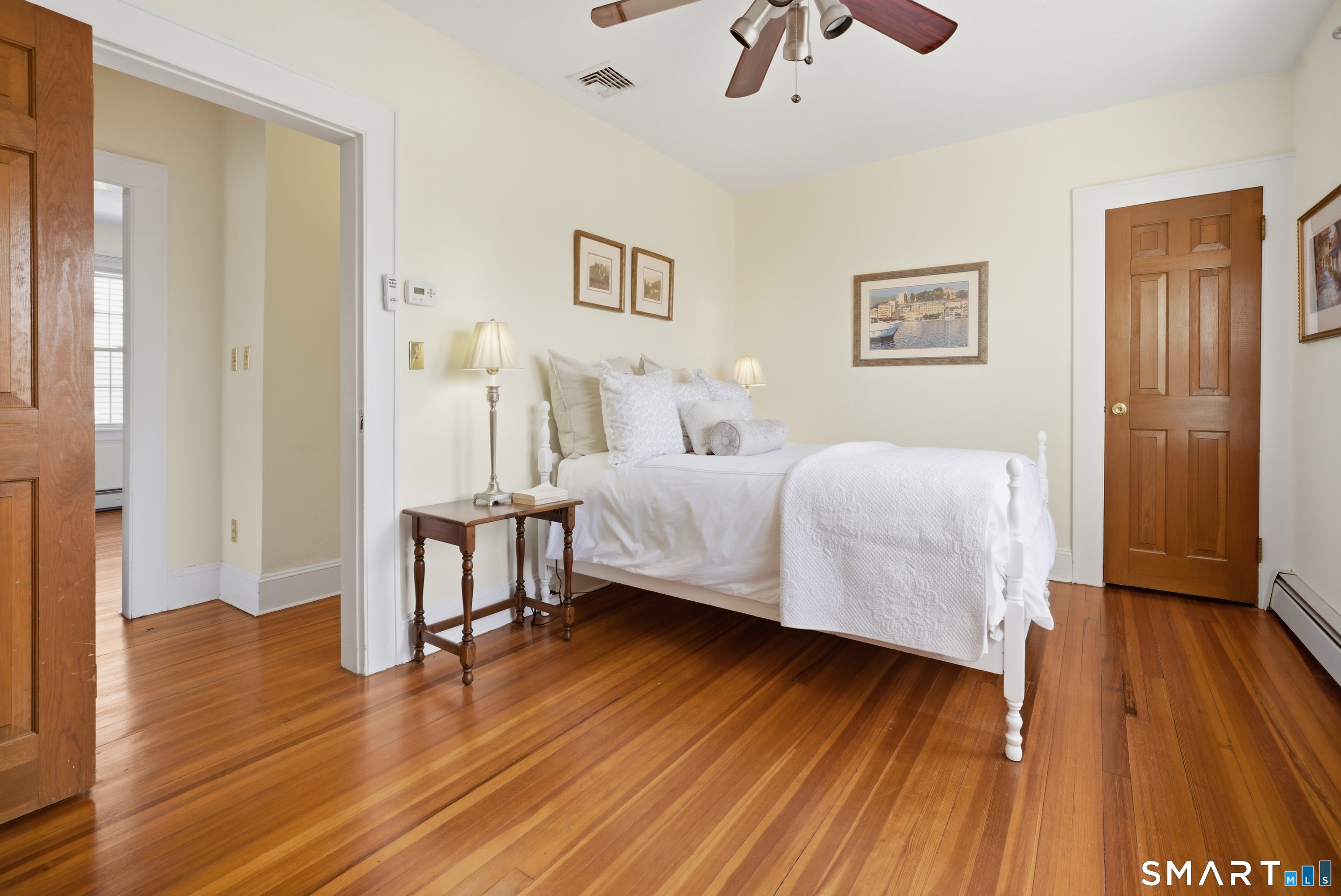 224 Homeland Street Fairfield, CT 06825 - Photo 21 of 37 a bedroom with a bed and a table