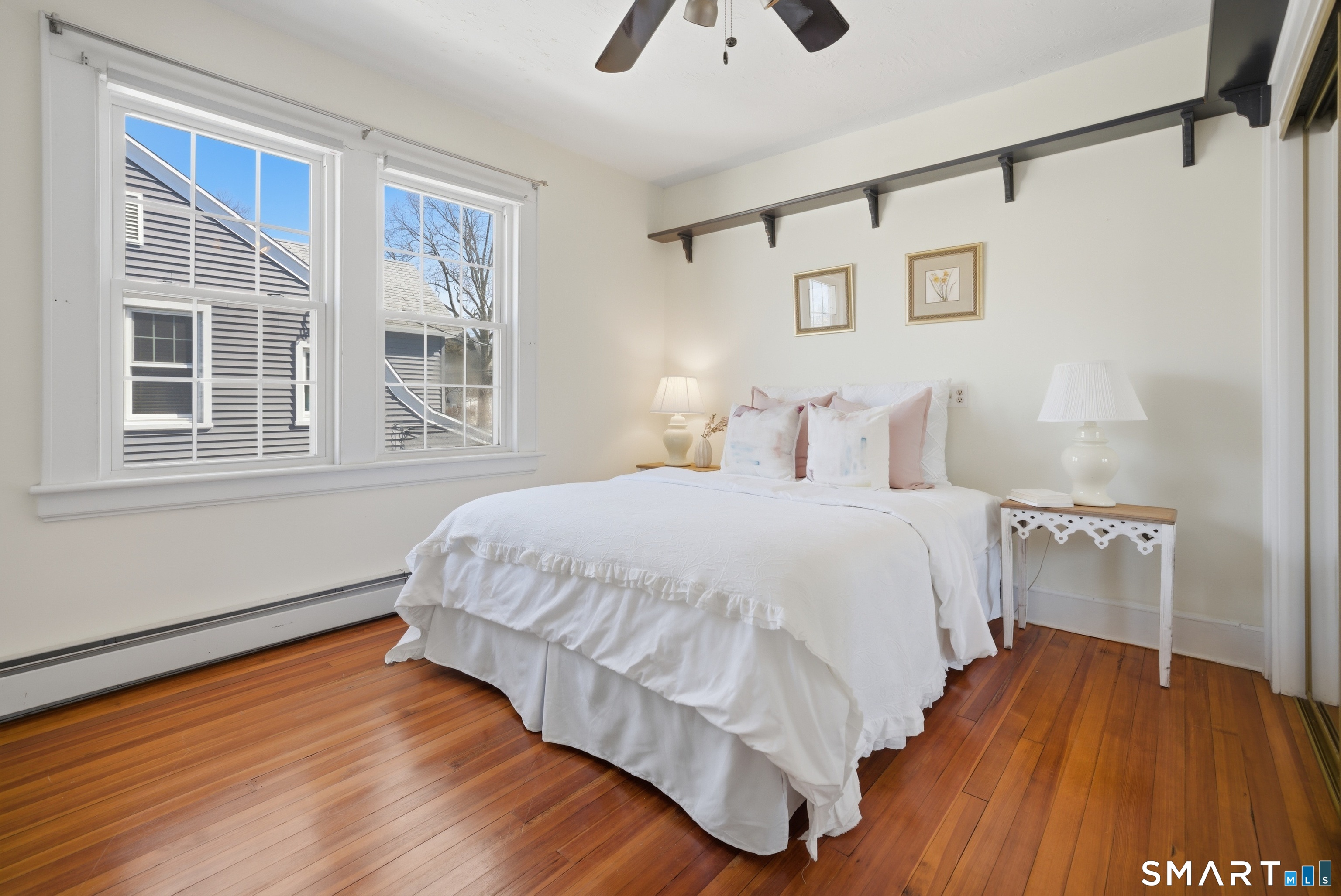 224 Homeland Street Fairfield, CT 06825 - Photo 22 of 37 a bedroom with a bed and wooden floor