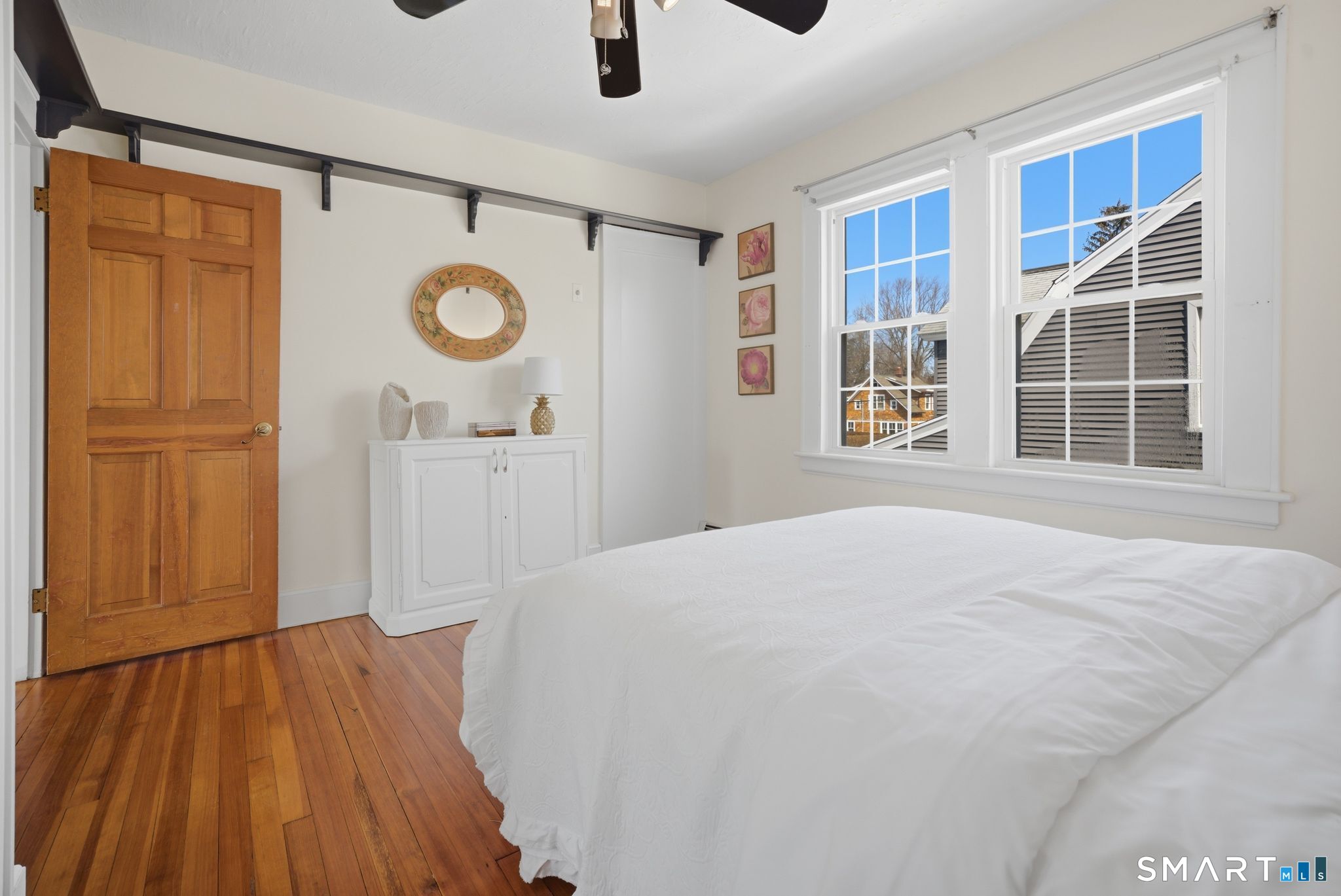 224 Homeland Street Fairfield, CT 06825 - Photo 23 of 37 a bedroom with a bed and a large window