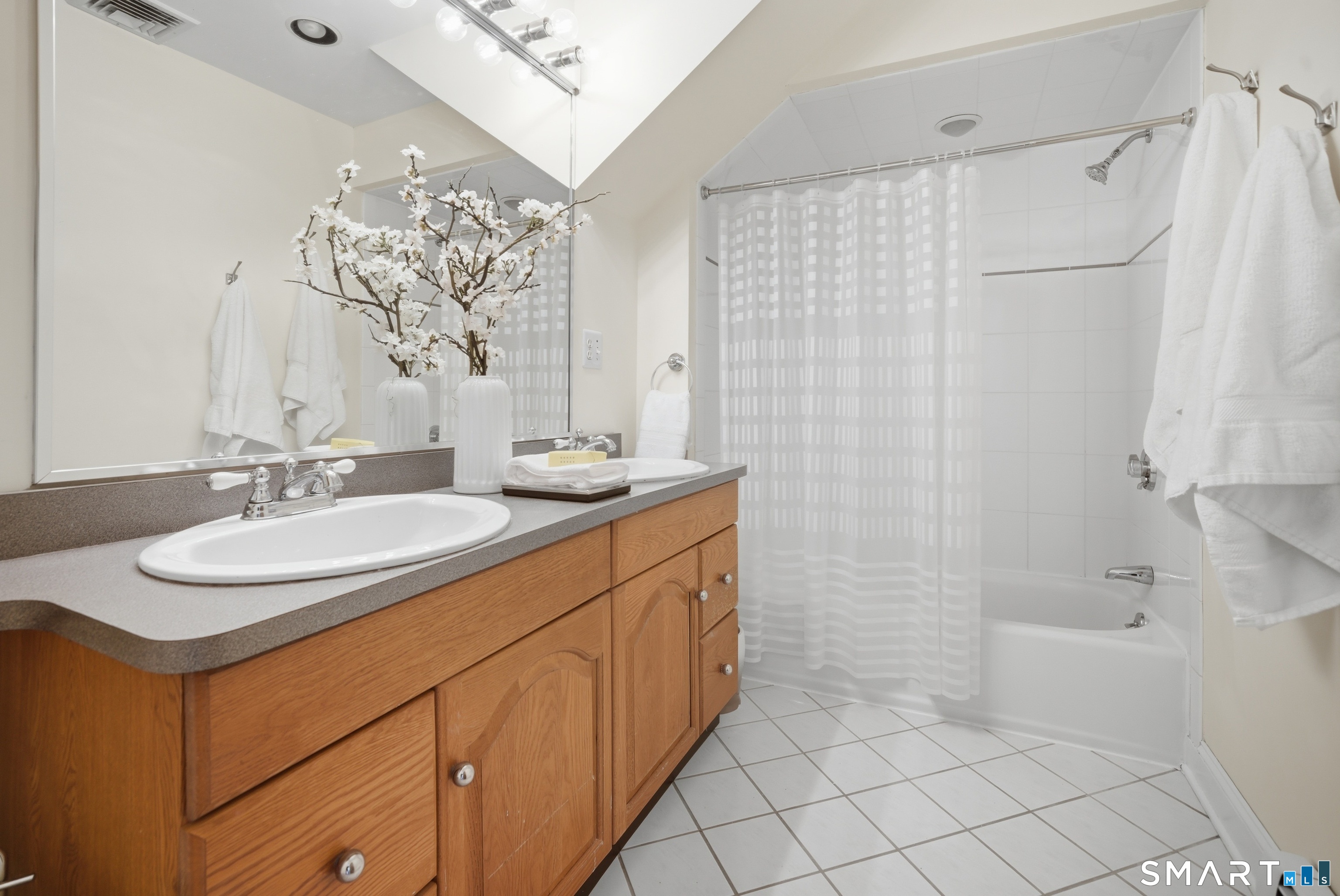 224 Homeland Street Fairfield, CT 06825 - Photo 24 of 37 a bathroom with a double vanity sink mirror and shower