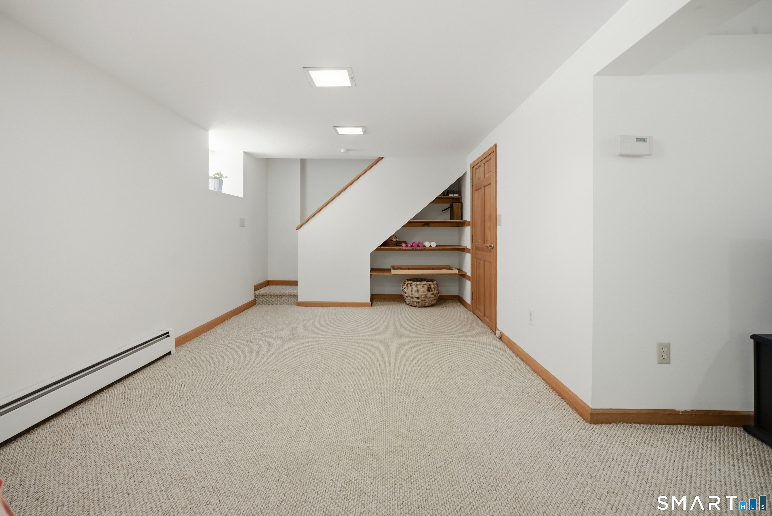 224 Homeland Street Fairfield, CT 06825 - Photo 27 of 37 a view of an empty room with stairs