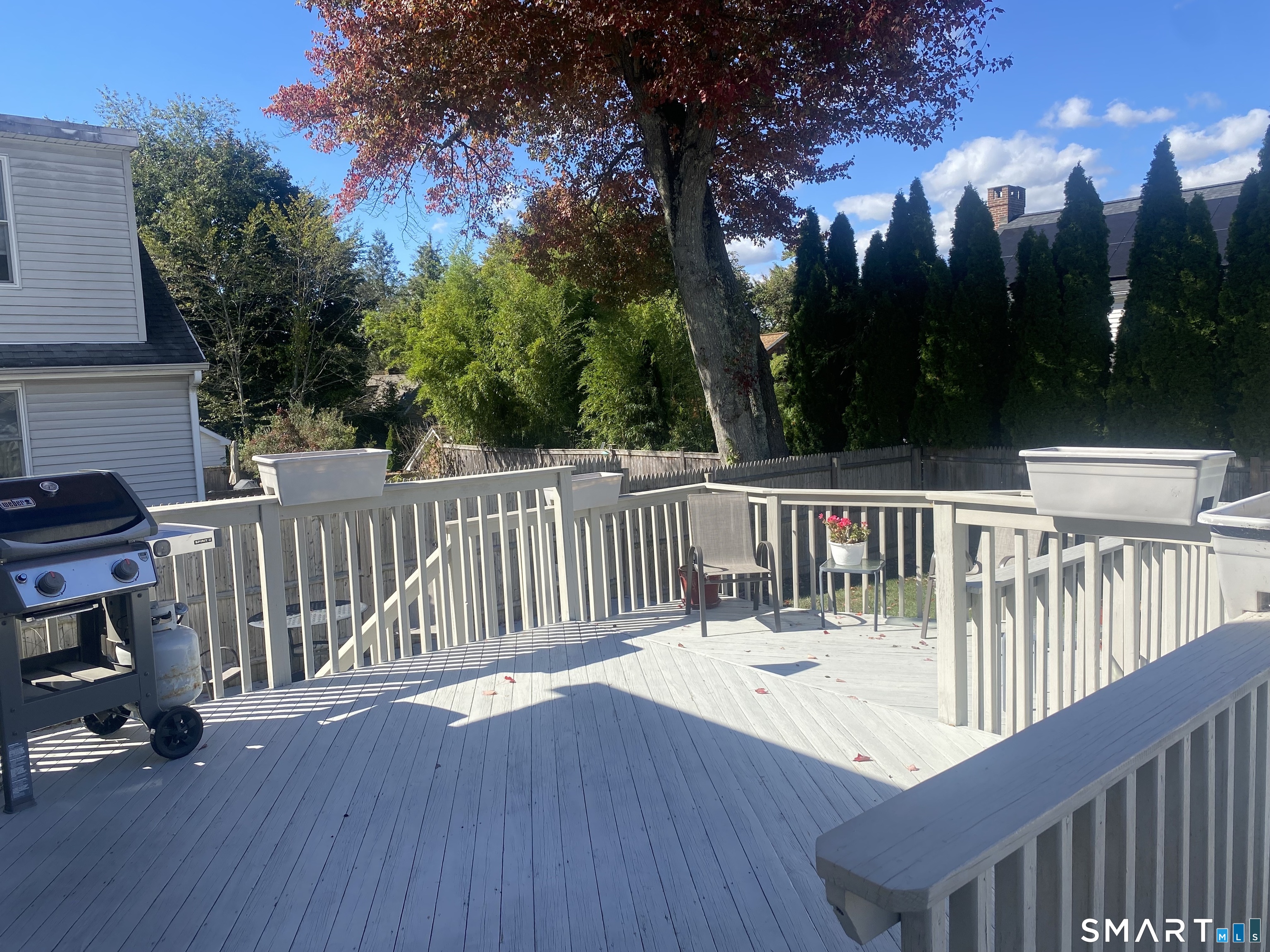 224 Homeland Street Fairfield, CT 06825 - Photo 31 of 37 a view of a deck with a chairs