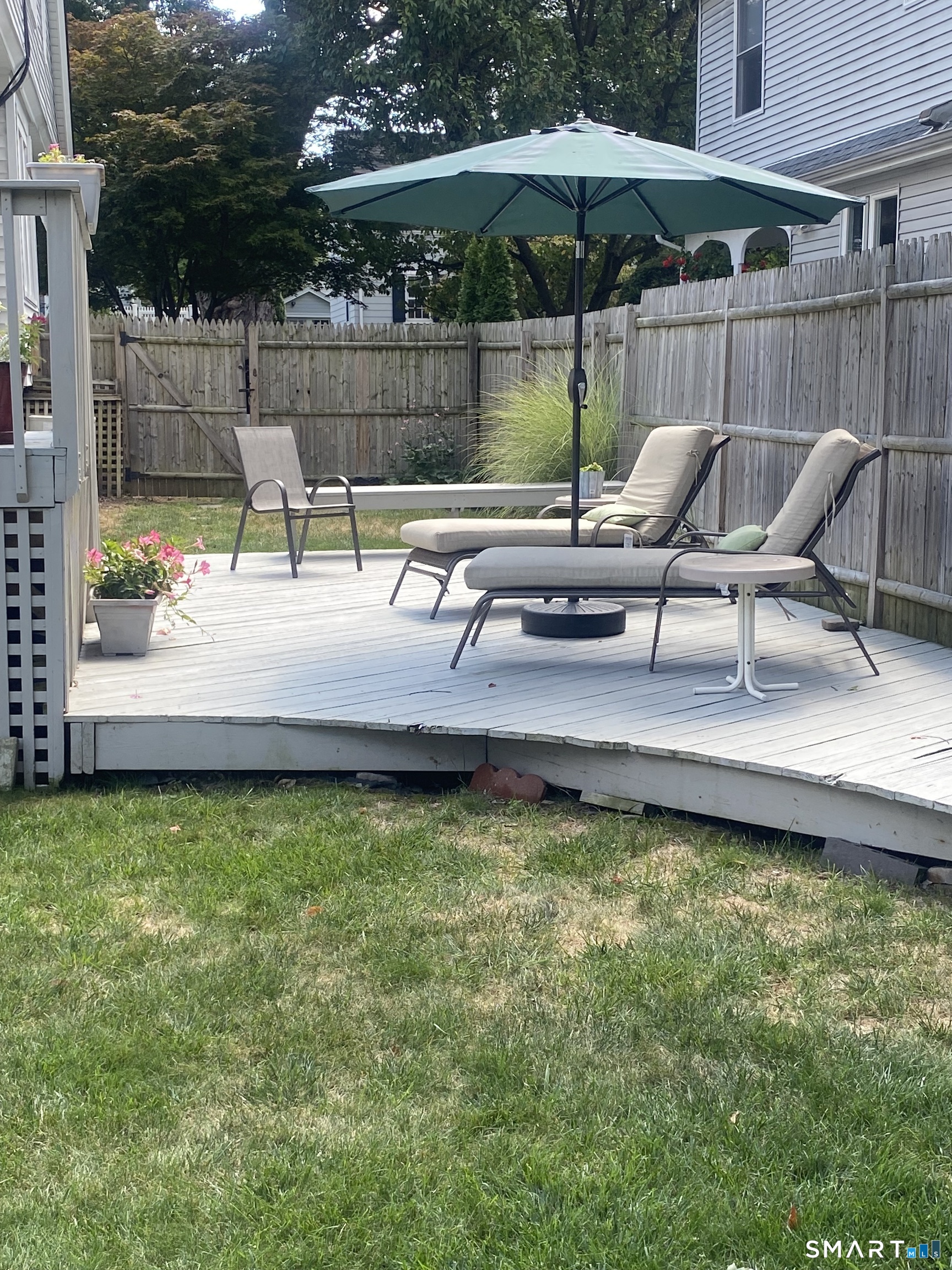 224 Homeland Street Fairfield, CT 06825 - Photo 32 of 37 a view of a backyard with sitting area and furniture