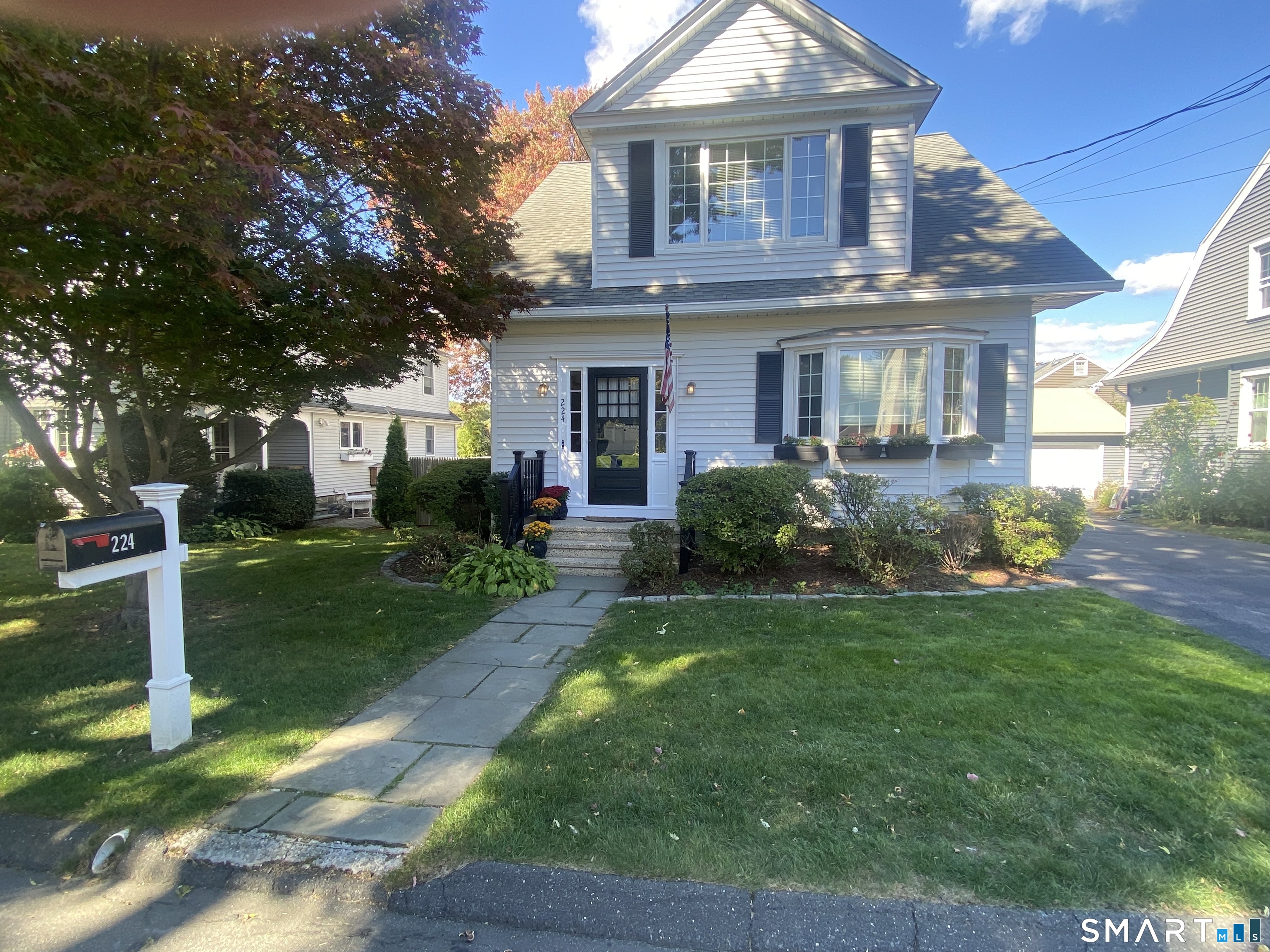 224 Homeland Street Fairfield, CT 06825 - Photo 33 of 37 a front view of a house with a yard and porch