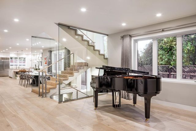 a living room with furniture and floor to ceiling windows