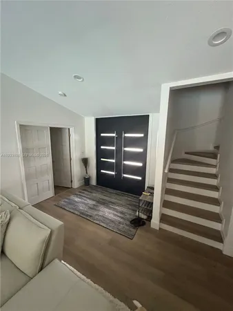 a view of an empty room with stairs and ventilation