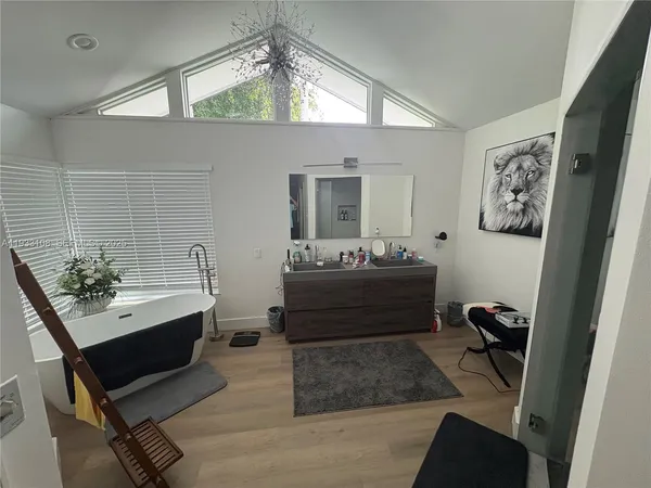 a room with a mirror and furniture