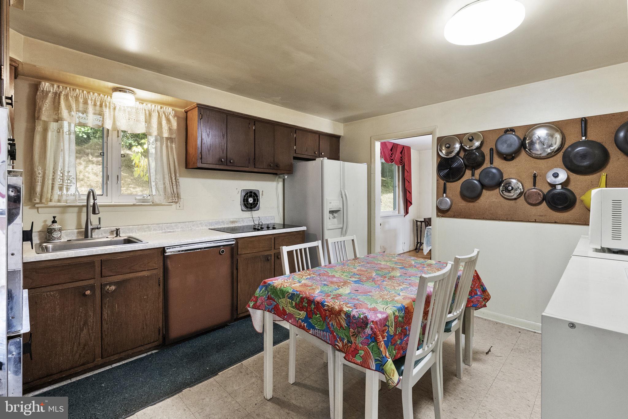 25 Hillendale Road Chadds Ford, PA 19317 - Photo 13 of 40 a kitchen that has a table chairs in it and wooden cabinets