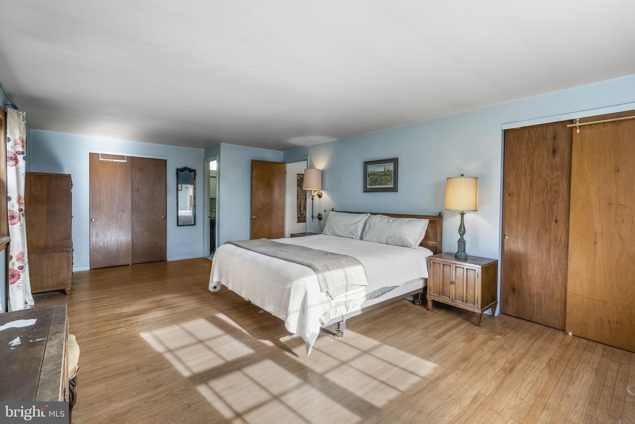 25 Hillendale Road Chadds Ford, PA 19317 - Photo 24 of 40 a bedroom with a bed and a lamp