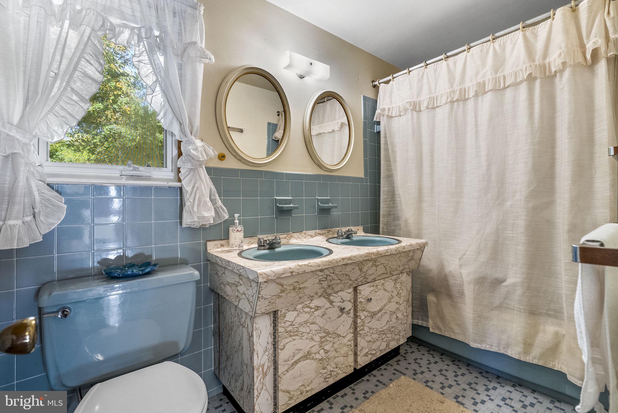 25 Hillendale Road Chadds Ford, PA 19317 - Photo 29 of 40 a bathroom with a sink a toilet and a shower curtain