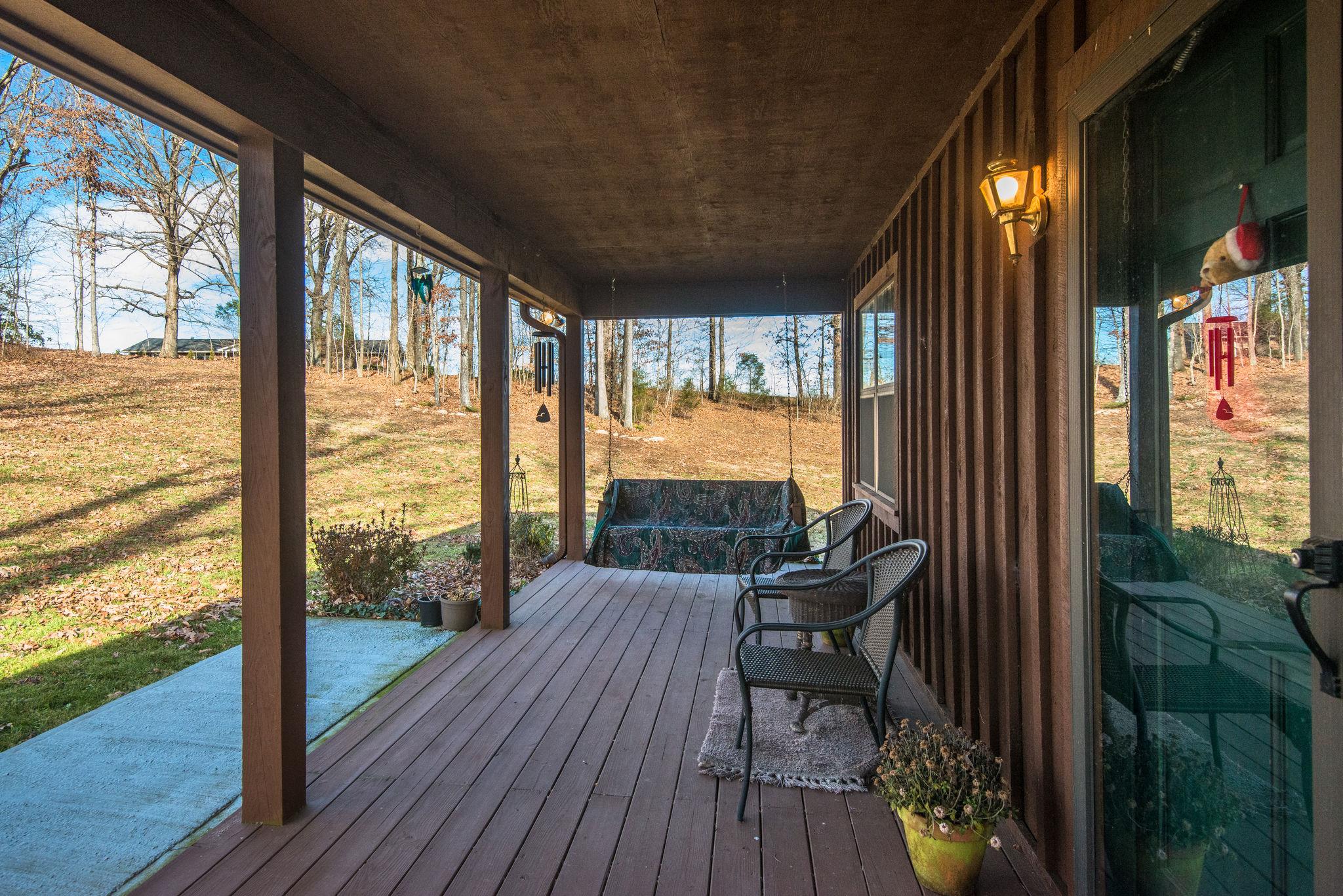 702 Mathis Road Charlotte, TN 37036 - Photo 3 of 22 This covered front porch and swing are perfect for morning coffee