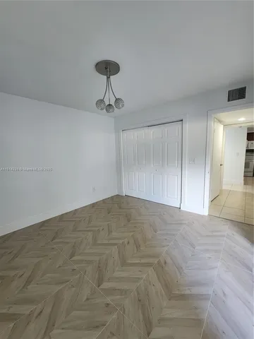 a view of empty room with a fan
