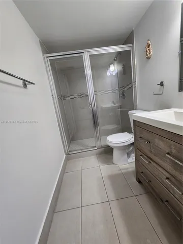 a bathroom with a shower and a toilet