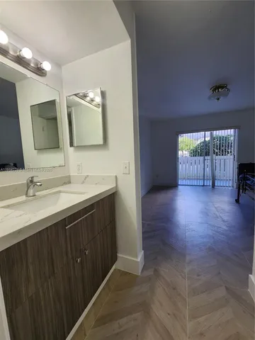a bathroom with a double vanity sink and a mirror