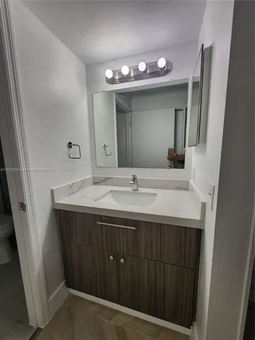 a bathroom with a glass shower and a toilet
