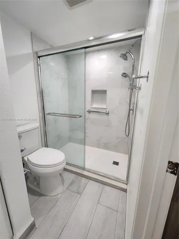 a bathroom with a shower and a toilet