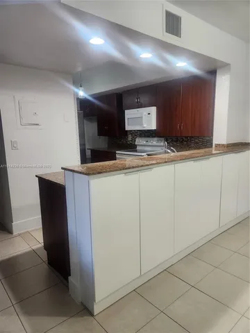 a kitchen with stainless steel appliances a sink and a refrigerator