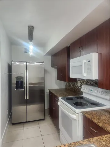 a kitchen with a sink and a refrigerator
