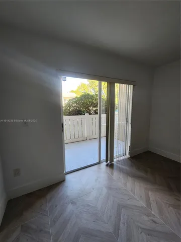 an empty room with large windows and city view