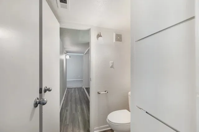 a bathroom with a toilet and a shower