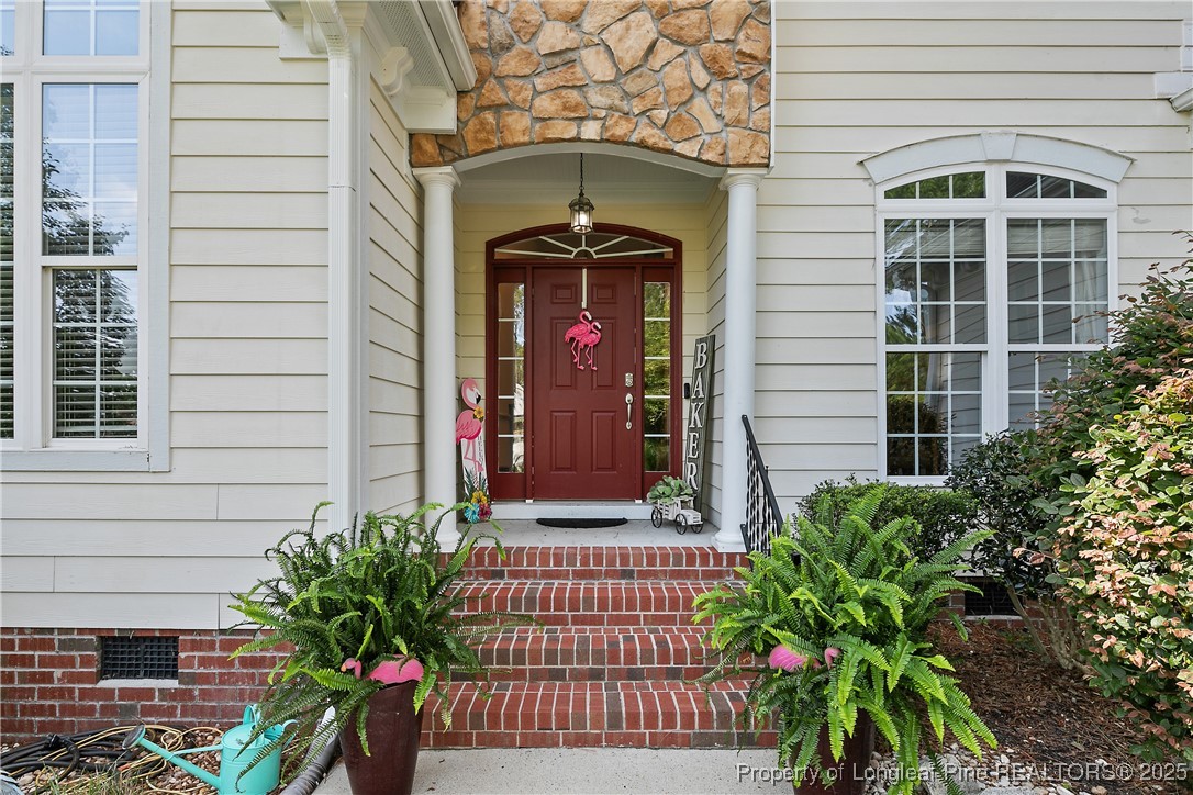 256 Barons Run West Spring Lake, NC 28390 - Photo 2 of 44 a front view of a house with a garden